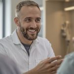Dentist smiling and talking to patients