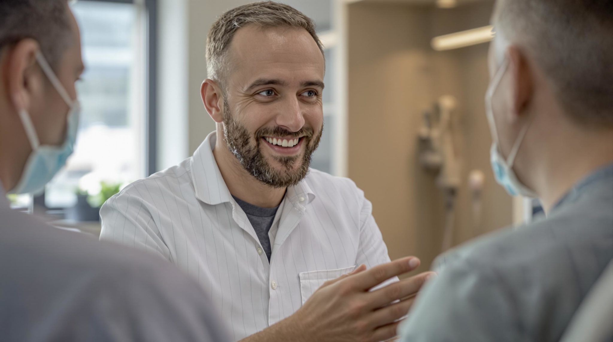 Dentist smiling and talking to patients